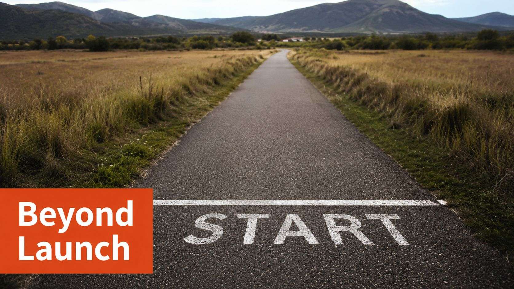 A paved path in a landscape with a white start line and the word START painted on it.